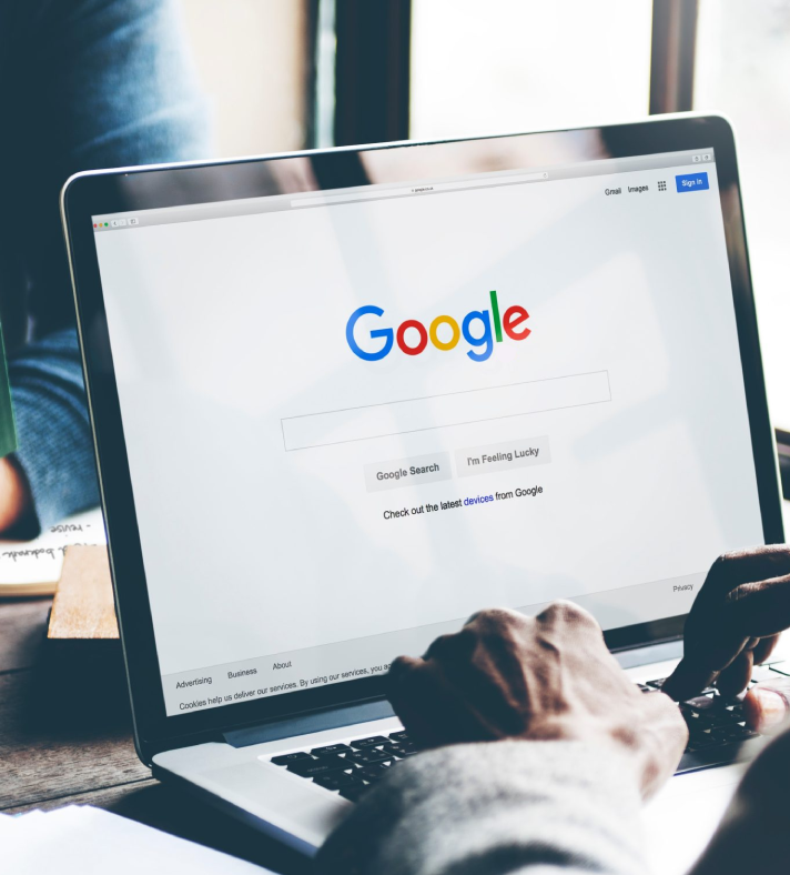 Search Engine Optimization (SEO) services graphic, showing Google search engine results page on a laptop in a bookstore.
